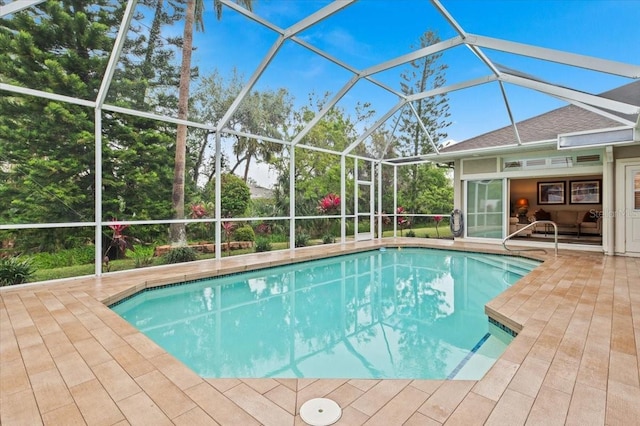 outdoor pool with a lanai and a patio