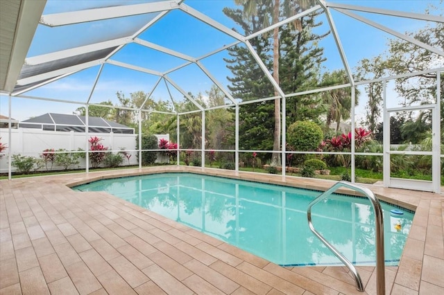 view of pool featuring a fenced in pool, a patio, and glass enclosure