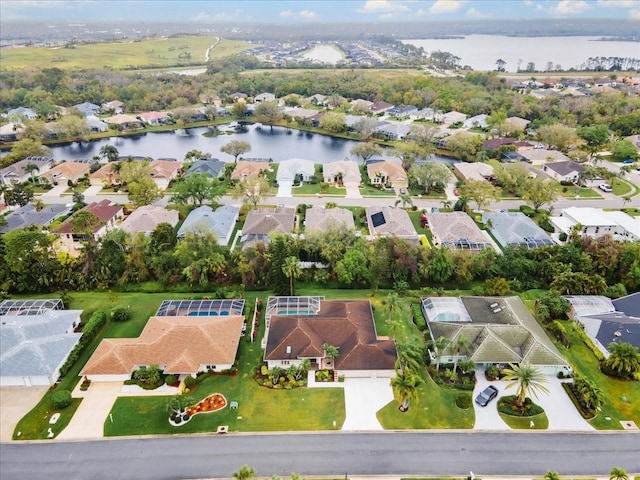 drone / aerial view featuring a residential view and a water view