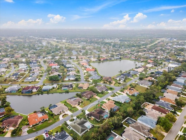 birds eye view of property featuring a residential view and a water view