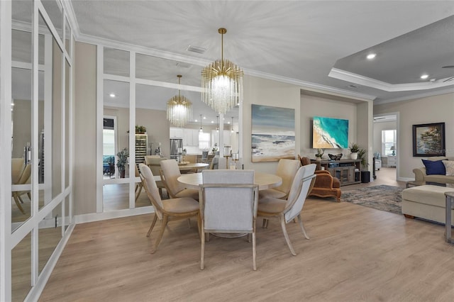 dining space featuring visible vents, light wood-style flooring, recessed lighting, ornamental molding, and a notable chandelier