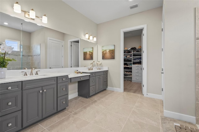 full bath featuring visible vents, a walk in shower, tile patterned flooring, baseboards, and vanity