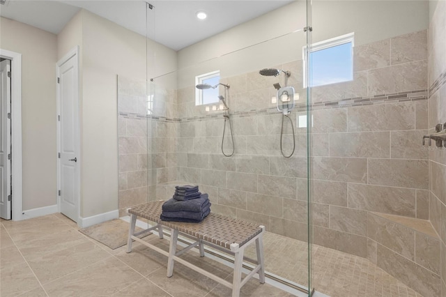 full bathroom with baseboards and a walk in shower