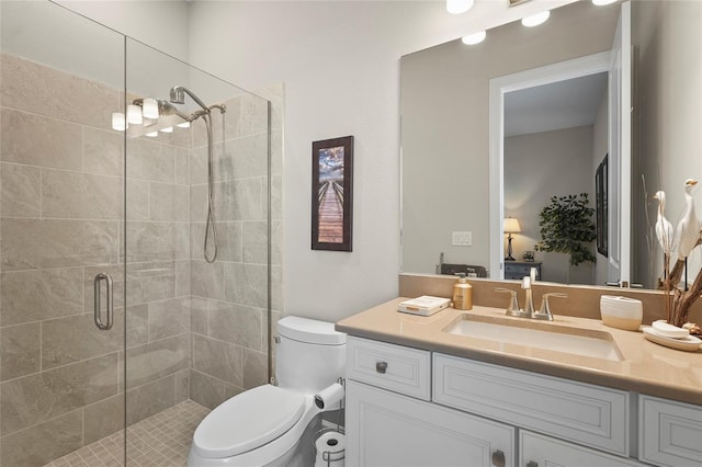 full bath featuring a stall shower, toilet, and vanity