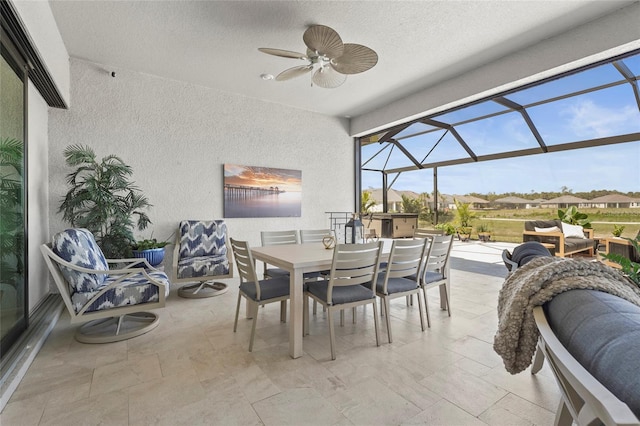 view of patio / terrace featuring ceiling fan, outdoor dining area, and a lanai