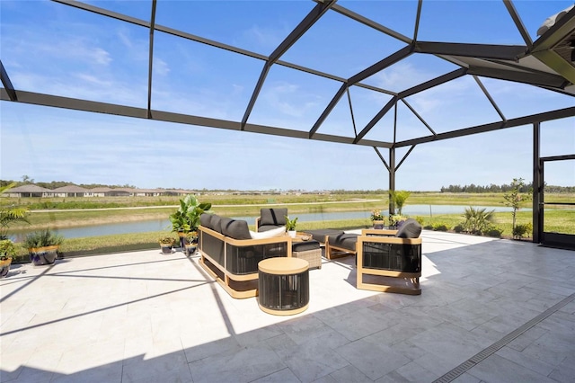 view of patio featuring glass enclosure, a water view, and outdoor lounge area