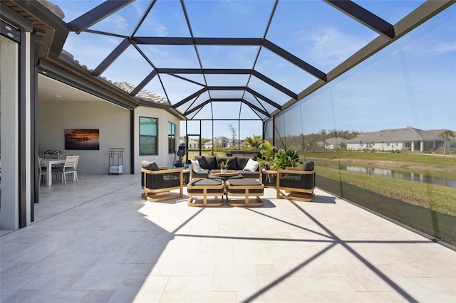 sunroom / solarium featuring a water view