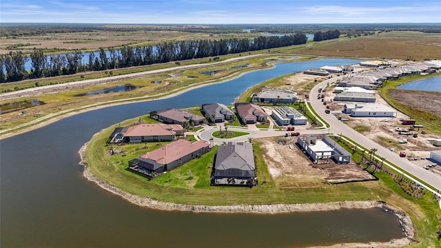 drone / aerial view featuring a residential view and a water view