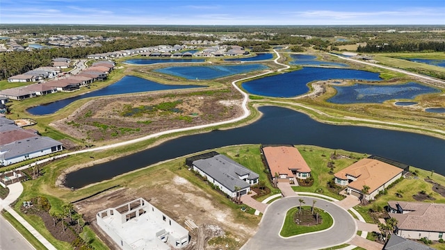 birds eye view of property with a water view and a residential view