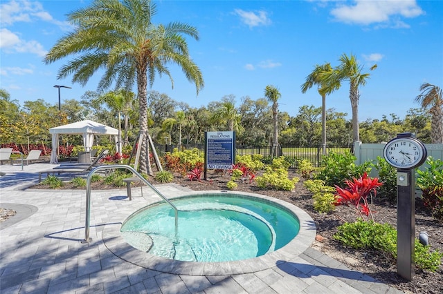 view of pool with a gazebo, a patio, a hot tub, and fence