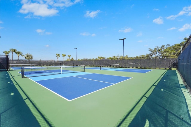 view of tennis court featuring fence