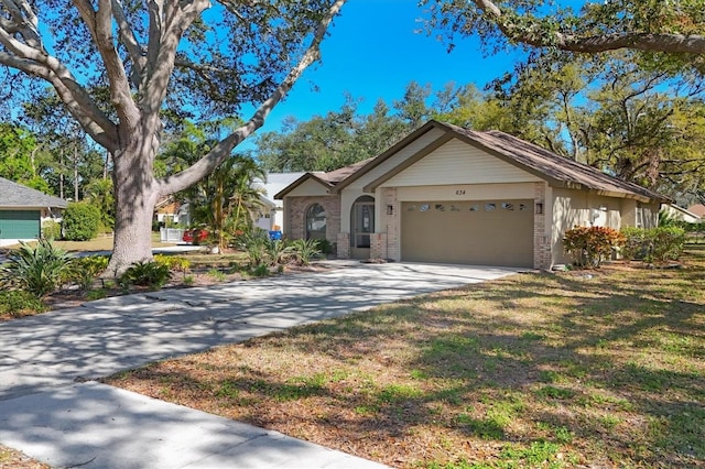 ranch-style home with an attached garage, brick siding, and driveway