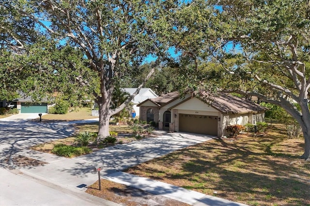 view of front of home featuring an attached garage and concrete driveway