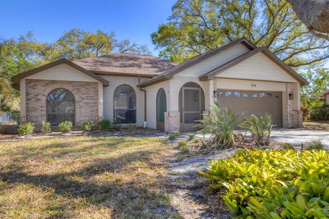 view of front of property featuring driveway, brick siding, and an attached garage