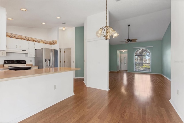 kitchen with range with electric cooktop, under cabinet range hood, wood finished floors, stainless steel fridge with ice dispenser, and light countertops