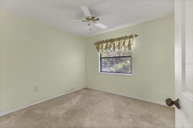 empty room with baseboards, a textured ceiling, a ceiling fan, and carpet floors