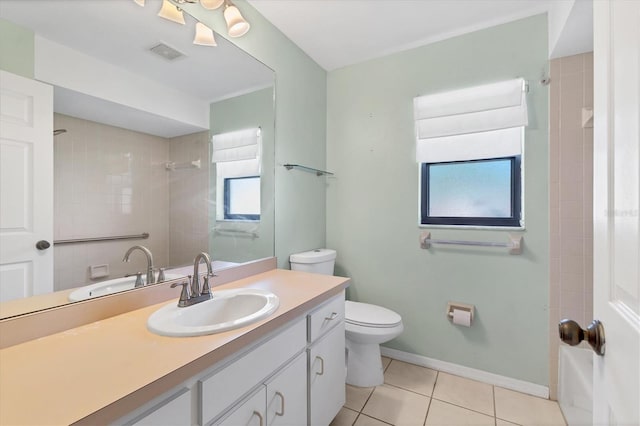 bathroom with vanity, baseboards, visible vents, tile patterned floors, and toilet