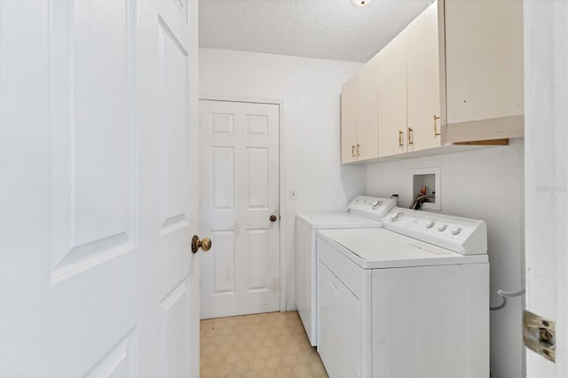 laundry area featuring cabinet space, a textured ceiling, independent washer and dryer, and light floors