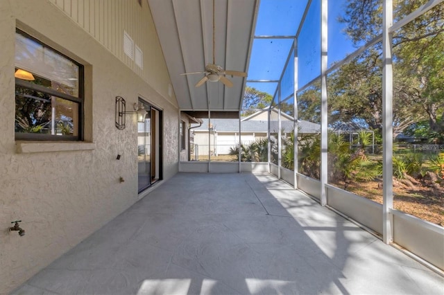 unfurnished sunroom featuring a ceiling fan