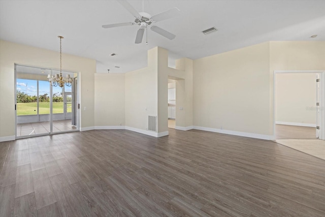 unfurnished living room featuring visible vents, baseboards, and dark wood-style floors