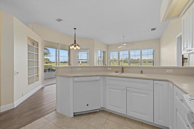 kitchen with visible vents, an inviting chandelier, a sink, light countertops, and dishwasher