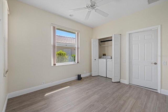 unfurnished bedroom with baseboards, light wood-style floors, a closet, a ceiling fan, and separate washer and dryer