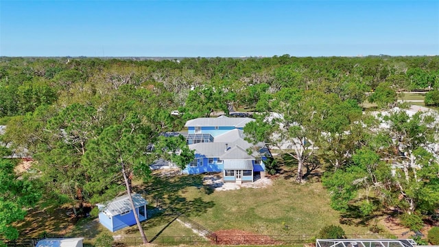 birds eye view of property with a view of trees