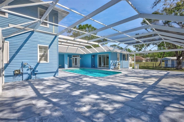 outdoor pool with a patio area, french doors, a lanai, and fence