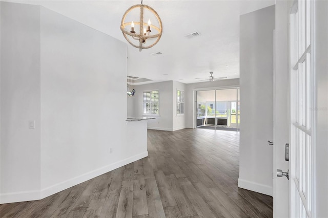 unfurnished living room with visible vents, baseboards, and wood finished floors