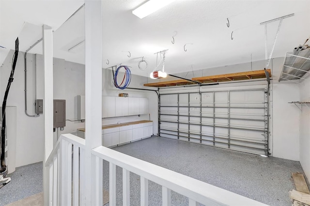 garage featuring electric panel and a garage door opener