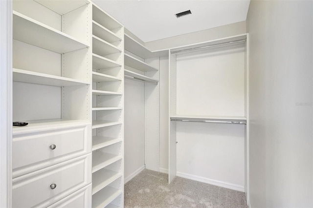 spacious closet featuring light carpet and visible vents