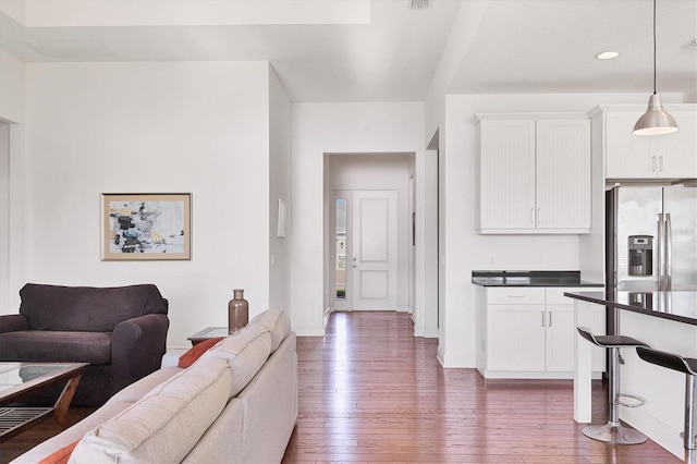 living area featuring baseboards and hardwood / wood-style floors