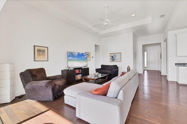 living area featuring dark wood-style floors, recessed lighting, a raised ceiling, and a ceiling fan