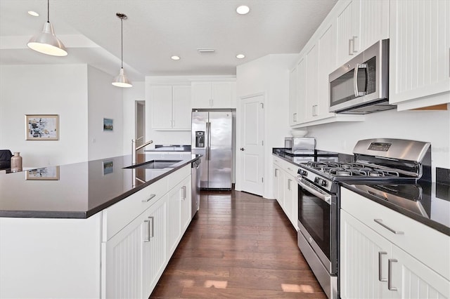 kitchen featuring a sink, dark countertops, visible vents, and stainless steel appliances