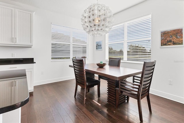 dining room with a notable chandelier, baseboards, and dark wood-style flooring