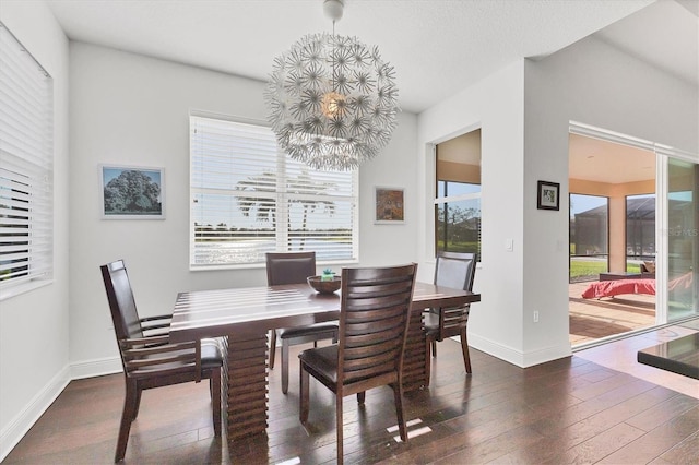 dining space with baseboards and hardwood / wood-style floors