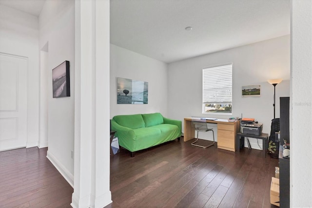 office space with dark wood finished floors and baseboards