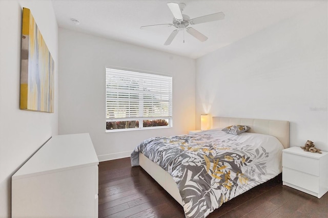 bedroom with baseboards, wood-type flooring, and a ceiling fan