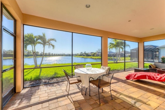 sunroom / solarium with a water view