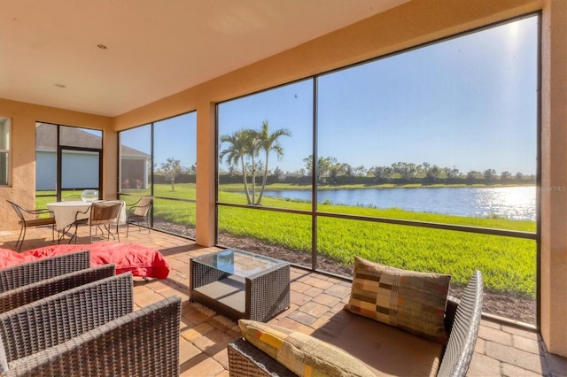 sunroom / solarium with a water view