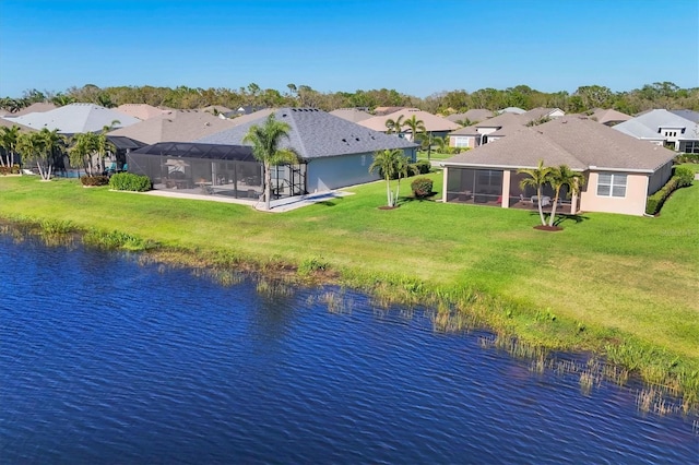 drone / aerial view with a residential view and a water view