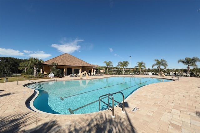 community pool with a patio area