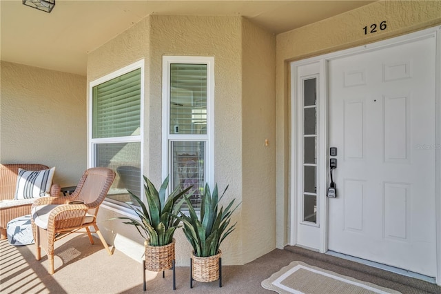 view of exterior entry with stucco siding