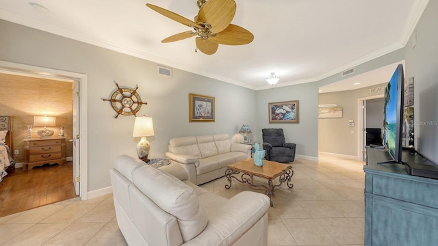 living room featuring visible vents, baseboards, light tile patterned flooring, and crown molding