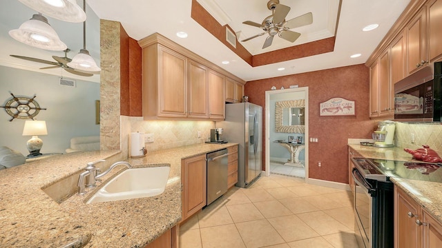 kitchen featuring visible vents, light stone counters, appliances with stainless steel finishes, a raised ceiling, and a sink