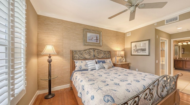 bedroom with visible vents, ornamental molding, baseboards, and wood finished floors