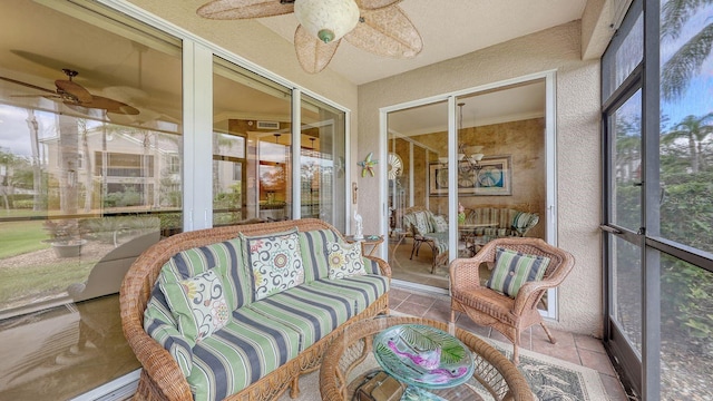 sunroom featuring a ceiling fan