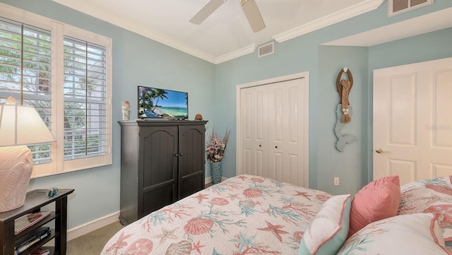 carpeted bedroom with visible vents, multiple windows, and a closet