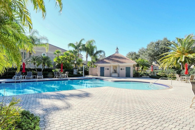 pool featuring a patio area and fence