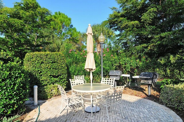 view of patio featuring outdoor dining space and a grill